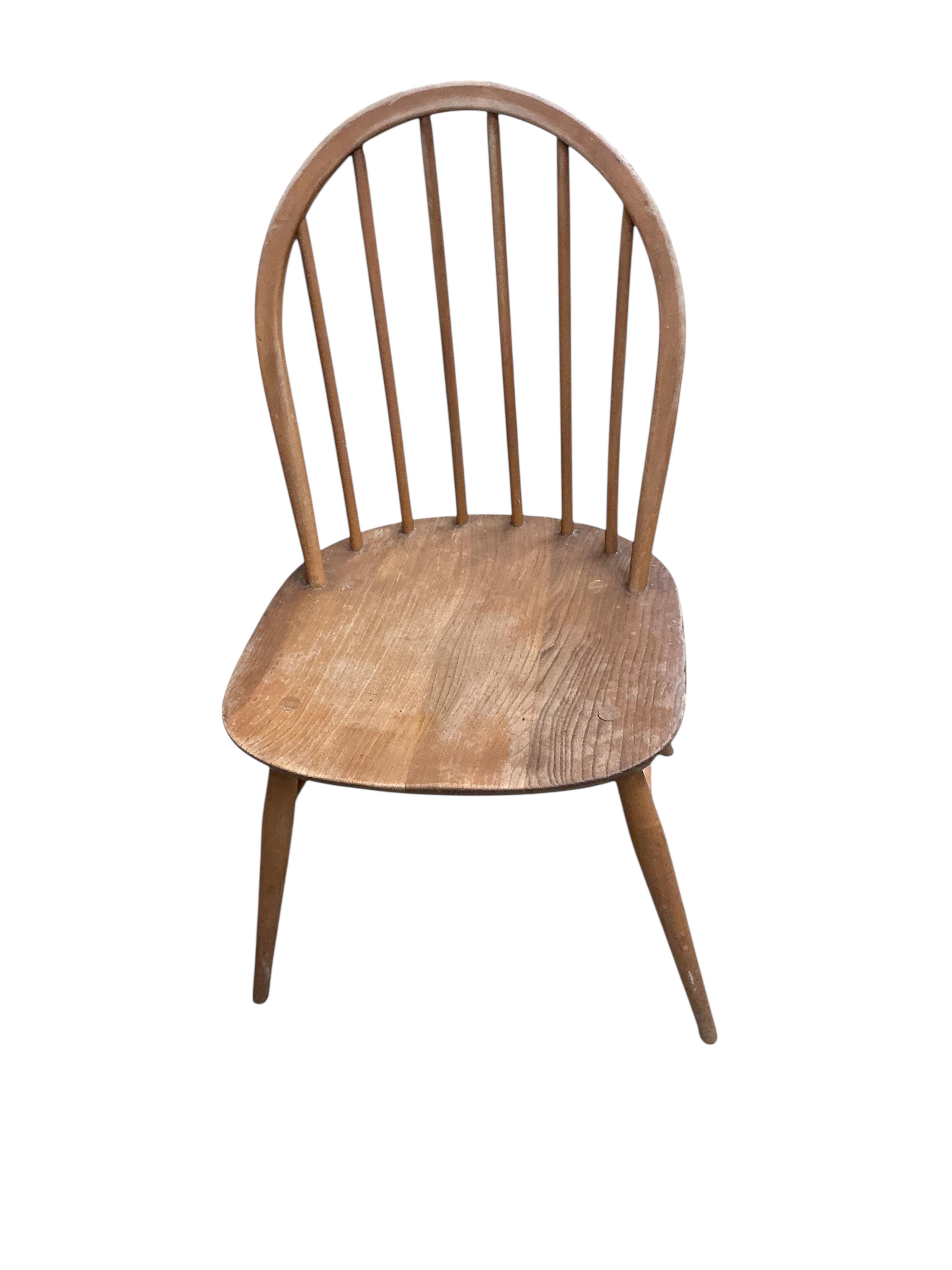 A set of six mid century Ercol elm and beech comb back chairs